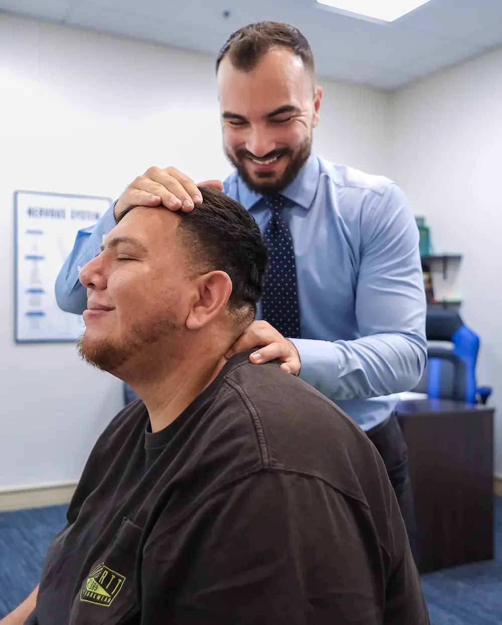 Chiropractor performing a neck exam at Momentum Chiropractic