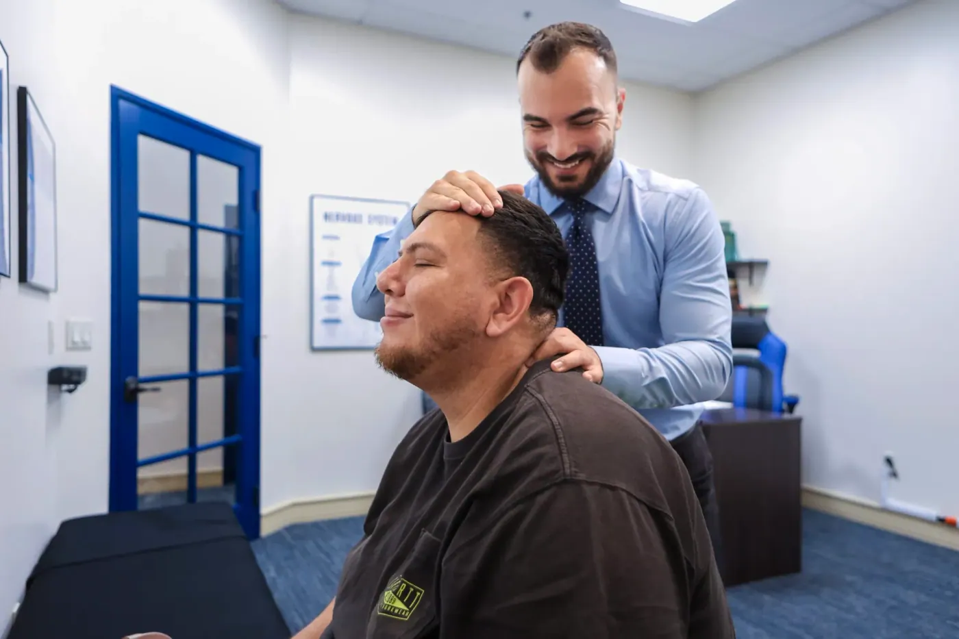 Dr David sedghi giving the patient a headache treatment