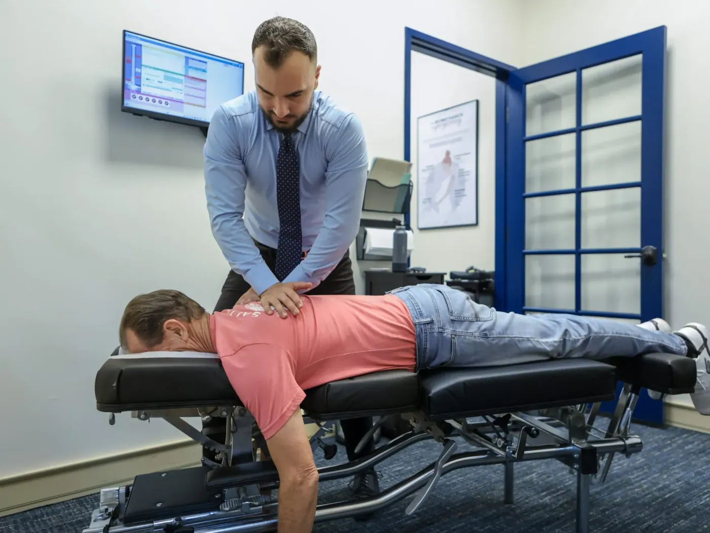 Dr David Sedghi giving the patient drop table adjustment