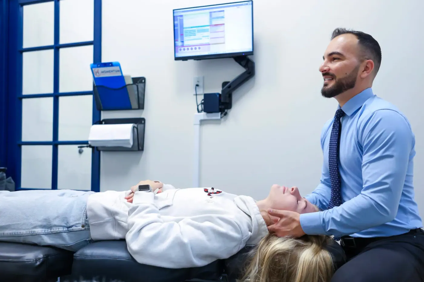 Dr David Sedghi giving the woman headache treatment