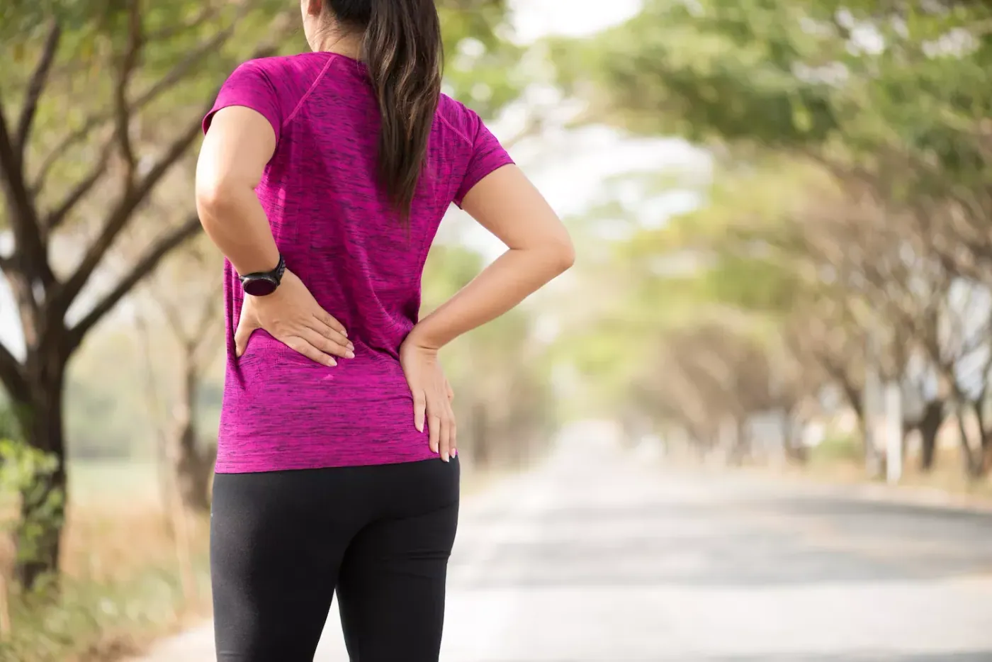 woman suffering from back pain after walking