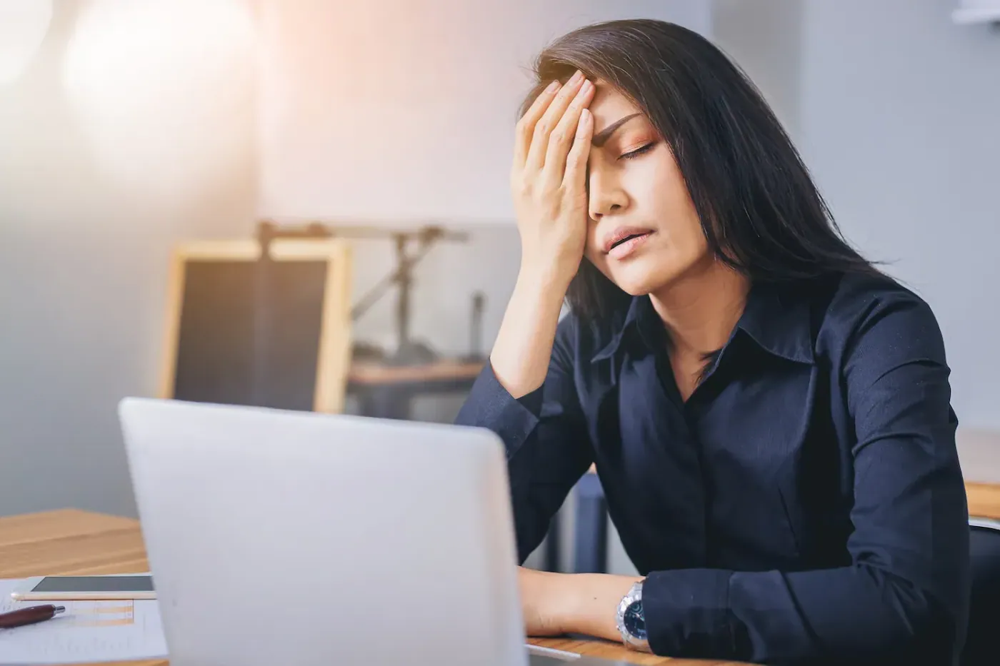 woman suffering from headache after her work
